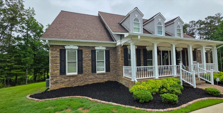 Custom brick construction with dormers and covered front porch